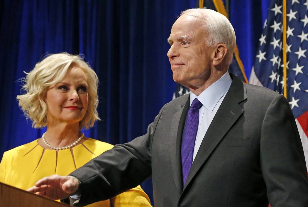 FILE - In this Tuesday, Nov. 8, 2016, file photo, Sen. John McCain, R-Ariz., right, pauses as h ...