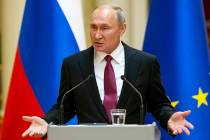 Russian President Vladimir Putin speaks during a news conference after his meeting with Preside ...