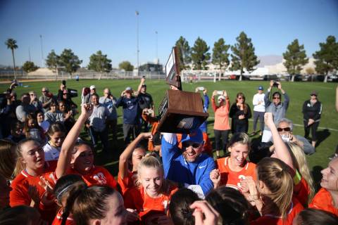 Bishop Gorman raise their trophy in celebration of their 4-0 win against Galena in the 4A girls ...