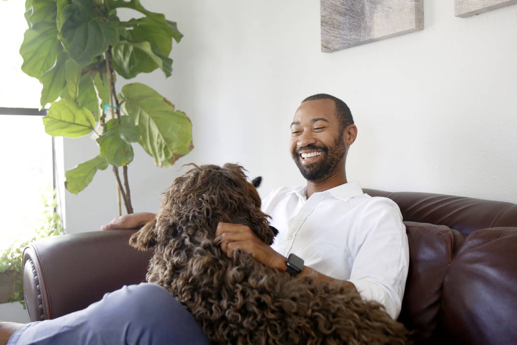 CEO of Silver State Health Ryan Linden with his dog, Murphy, in his office at the Silver State ...