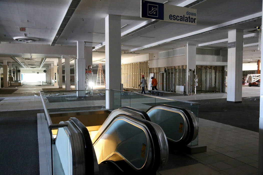Workers recycle building material inside the former Sears store is shown at the Boulevard Mall ...