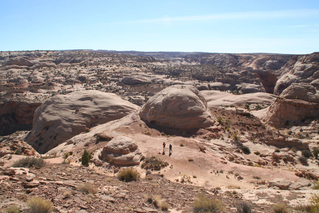 Hikers head down the slickrock toward Horseshoe Canyon in Canyonlands National Park. (Deborah W ...