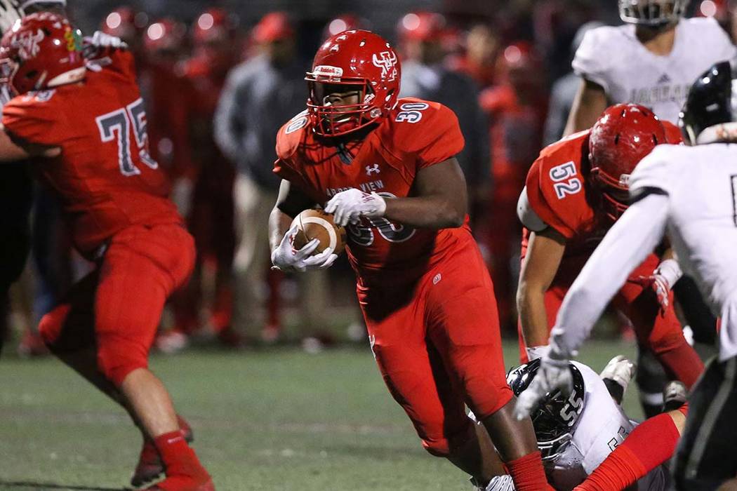 Arbor View's Darius Williams (30) runs through a pocket during second half of the Mountain Regi ...