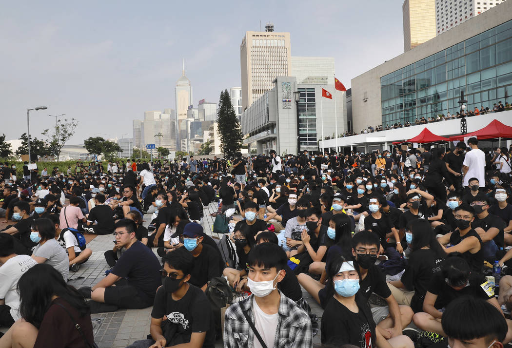 Students and others gather during a demonstration at Edinburgh Place in Hong Kong, Thursday, Au ...