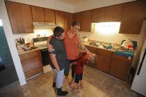 Misty Dotson hugs her son's at their home Tuesday, Aug. 20, 2019, in Murray, Utah. Dotson is a ...