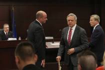 Dr. Tony Alamo, left, chairman of the Nevada Gaming Commission, watches as Matt Maddox, CEO of ...