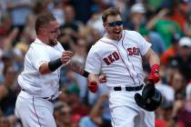 Boston Red Sox's Brock Holt, right, celebrates his game-winning RBI single with Christian Vazqu ...