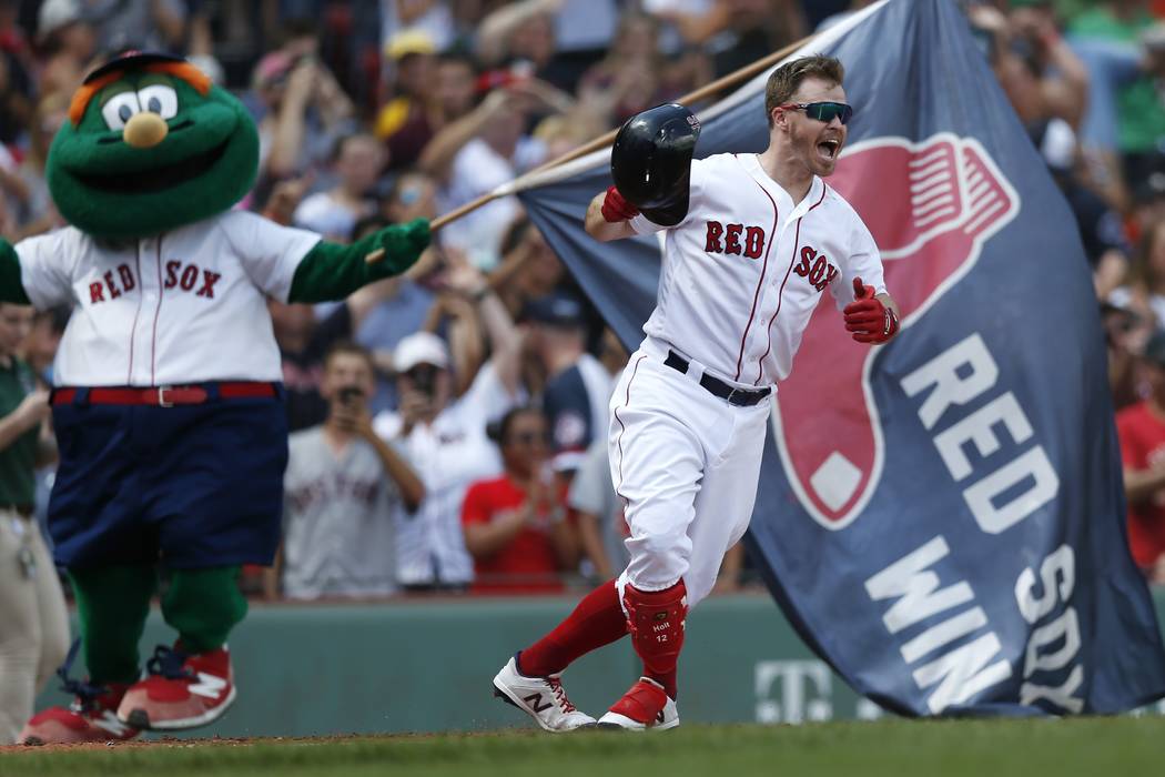 Boston Red Sox's Brock Holt celebrates his game-winning RBI single during the 10th inning of a ...