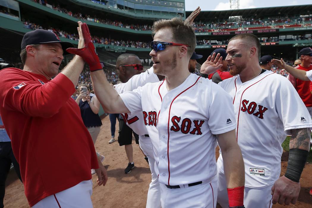 Boston Red Sox's Brock Holt, center, celebrates is game-winning RBI single during the 10th inni ...