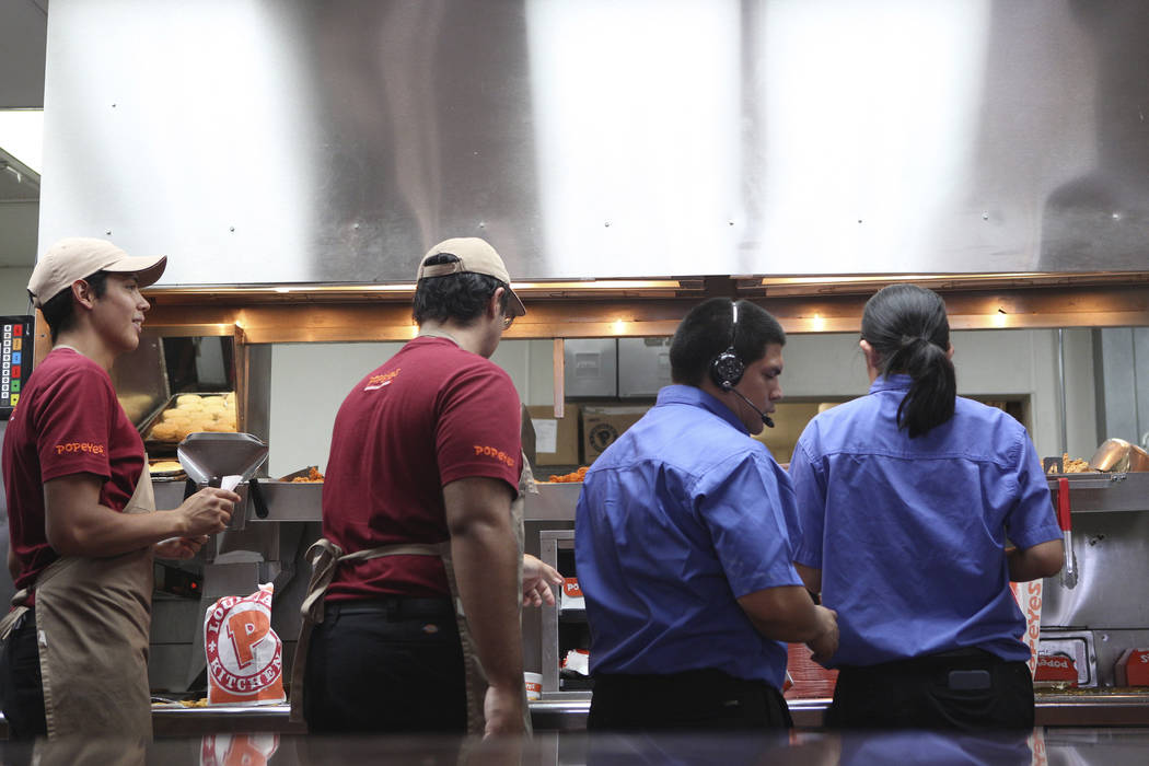 Popeyes employees work around the clock to fulfill orders of the new chicken sandwich at Popeye ...