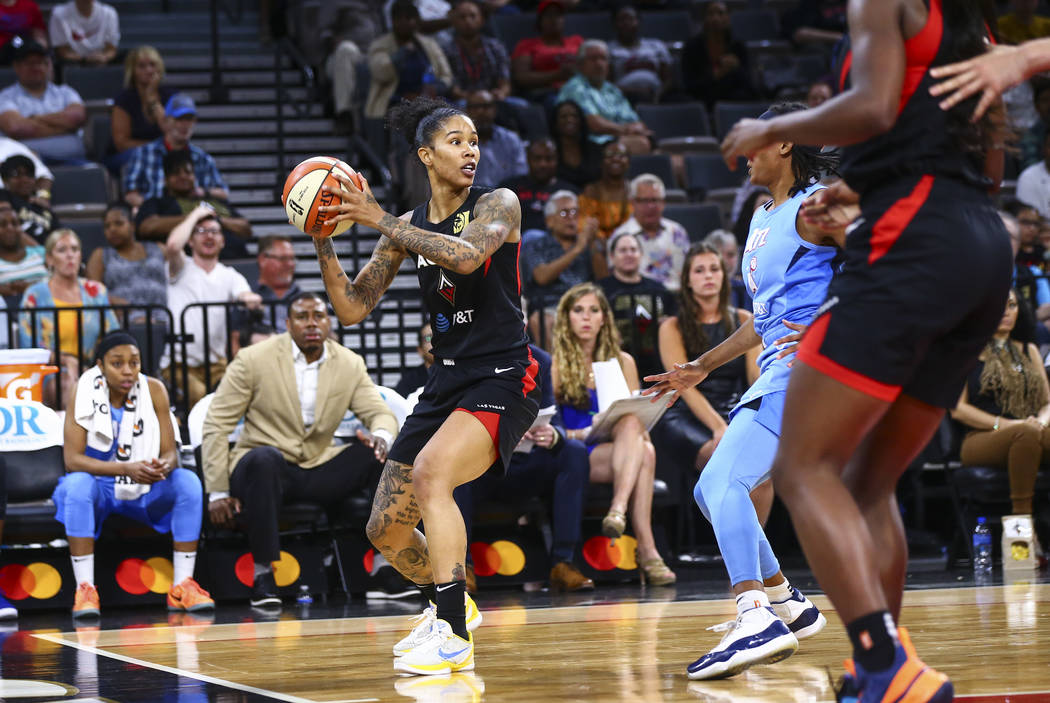 Las Vegas Aces' Tamera Young looks to pass the ball during the second half of a WNBA basketball ...