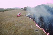 In this Aug. 20, 2019 drone photo released by the Corpo de Bombeiros de Mato Grosso, brush fire ...