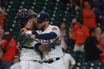 Houston Astros closer Roberto Osuna, right, celebrates with catcher Martin Maldonado as they de ...