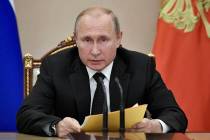 Russian President Vladimir Putin speaks at a meeting with members of the Security Council in th ...