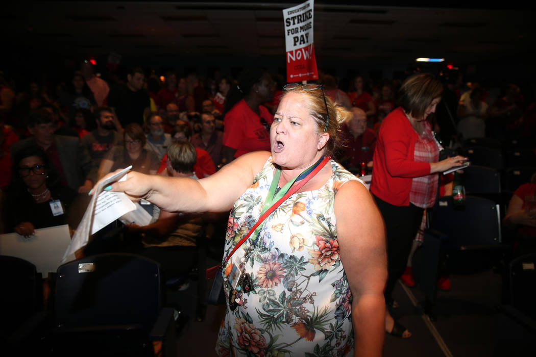 Nichole Beer, teacher librarian at Martinez Elementary School, chants "strike" during ...