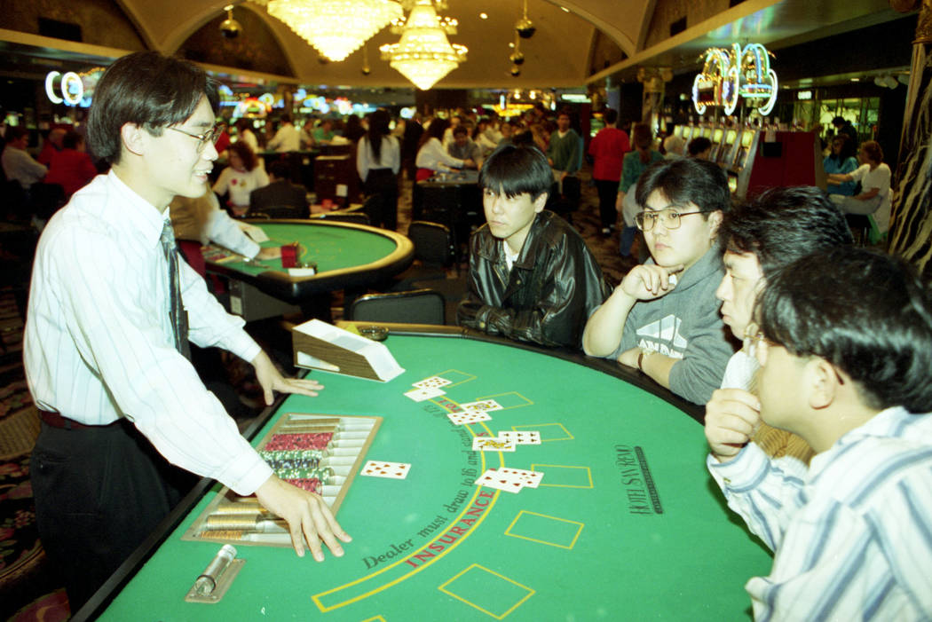 In this 1994 file photo, San Remo Hotel instructor Keita Miyoshi explains blackjack to Akira Su ...