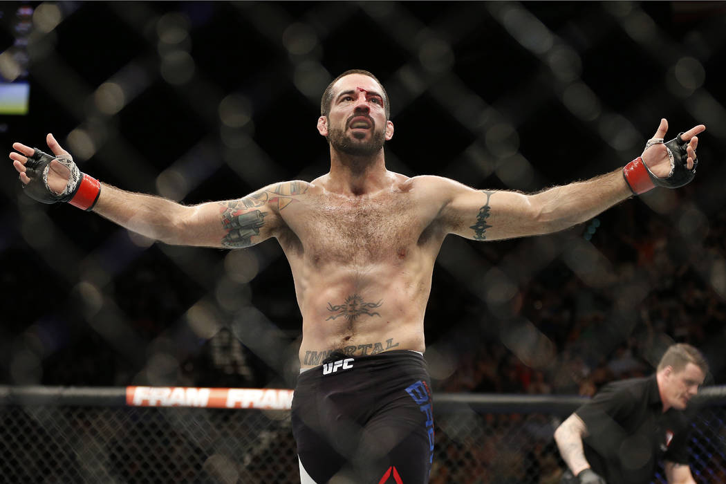 Matt Brown celebrates after defeating Tim Means during their welterweight mixed martial arts bo ...