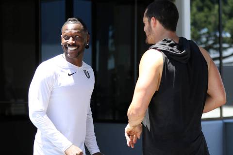 Oakland Raiders wide receiver Antonio Brown meets with quarterback Derek Carr after an offseaso ...