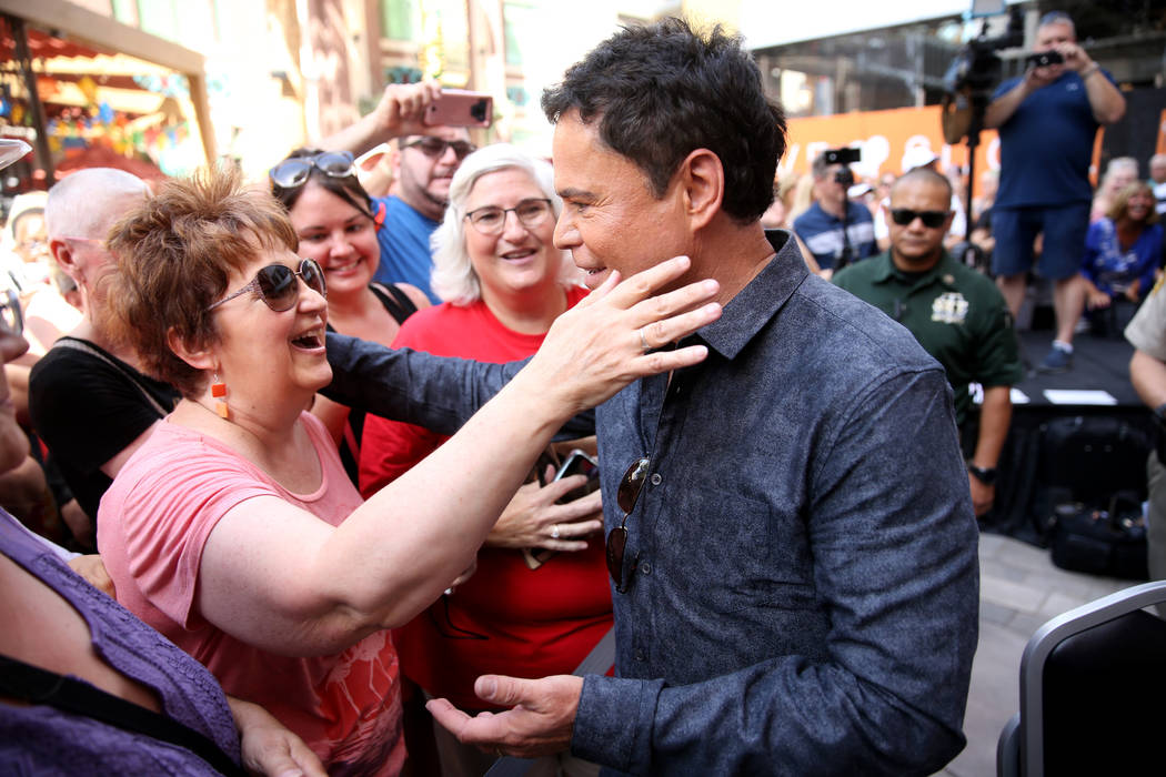 Strip headliner Donny Osmond hugs Elaine Swails of Orem, Utah after receiving a Key to The Las ...