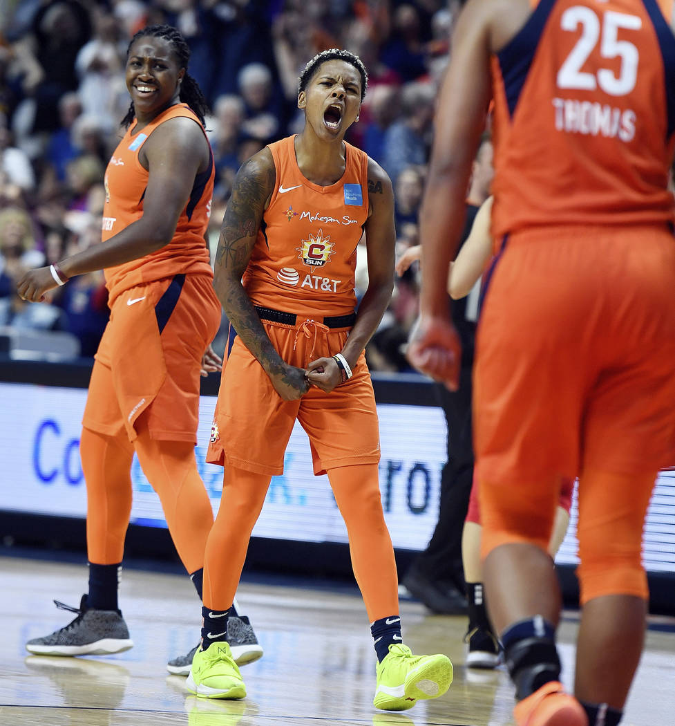 Connecticut Sun guard Courtney Williams, center, celebrates with teammates Shekinna Stricklen, ...