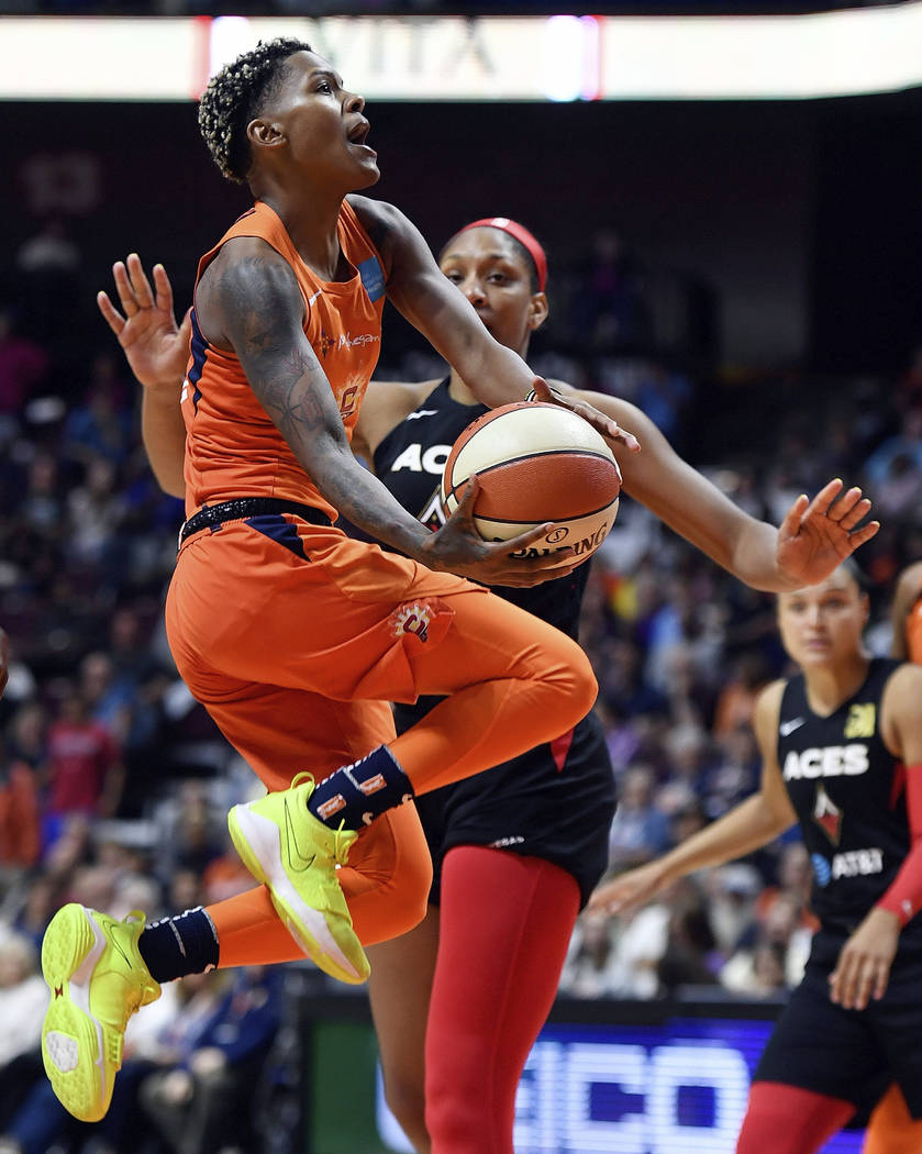 Connecticut Sun guard Courtney Williams puts up her shot as she is fouled by Las Vegas Aces for ...