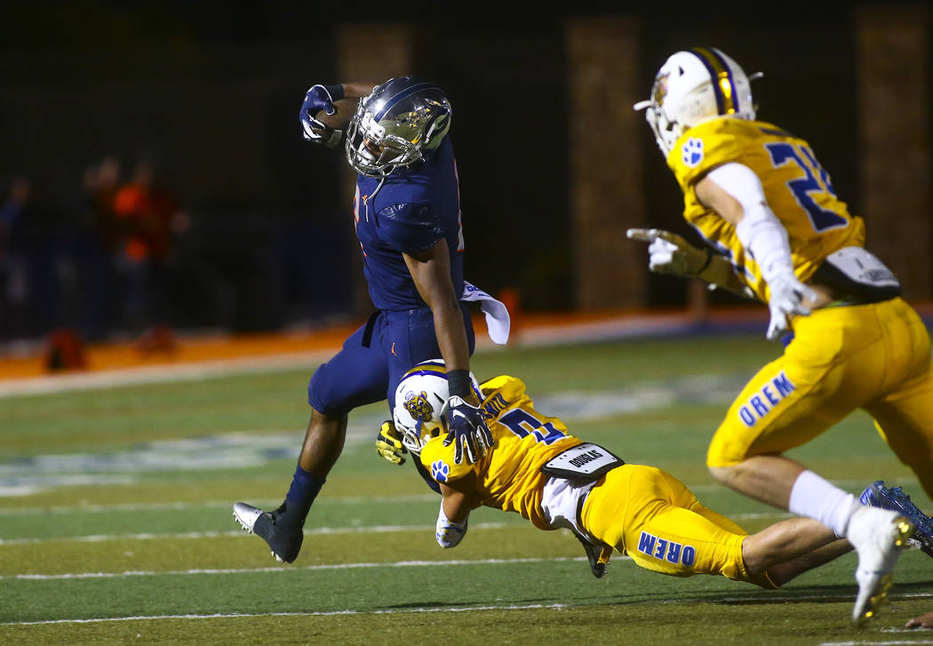 Bishop Gorman's Ikaika Ragsdale is stopped by Orem's Joe Smith (9) during the second half of a ...