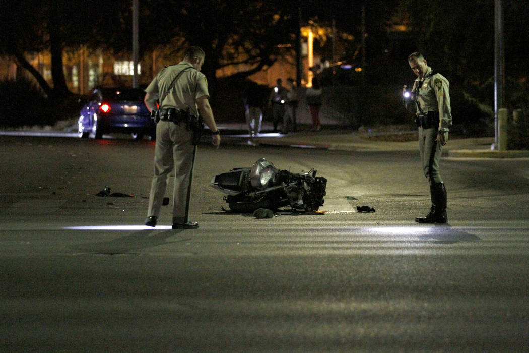 Las Vegas police officers investigate a fatal motorcycle crash at Martin Luther King Boulevard ...