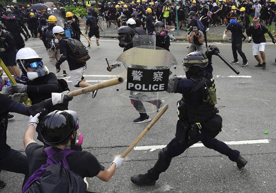 Police and demonstrators clash during a protest in Hong Kong, Saturday, Aug. 24, 2019. Chinese ...