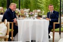 U.S President Donald Trump sits for lunch with French President Emmanuel Macron, right, at the ...