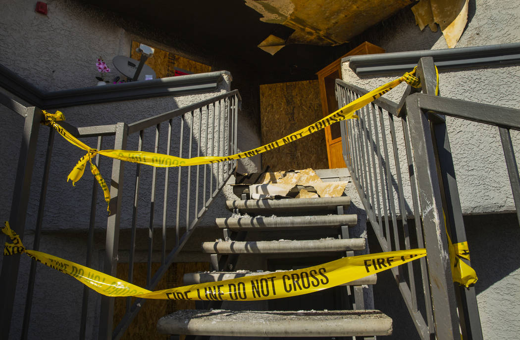 Fire department warning tape blocks the upstairs entrance from an early morning fire at The Bri ...