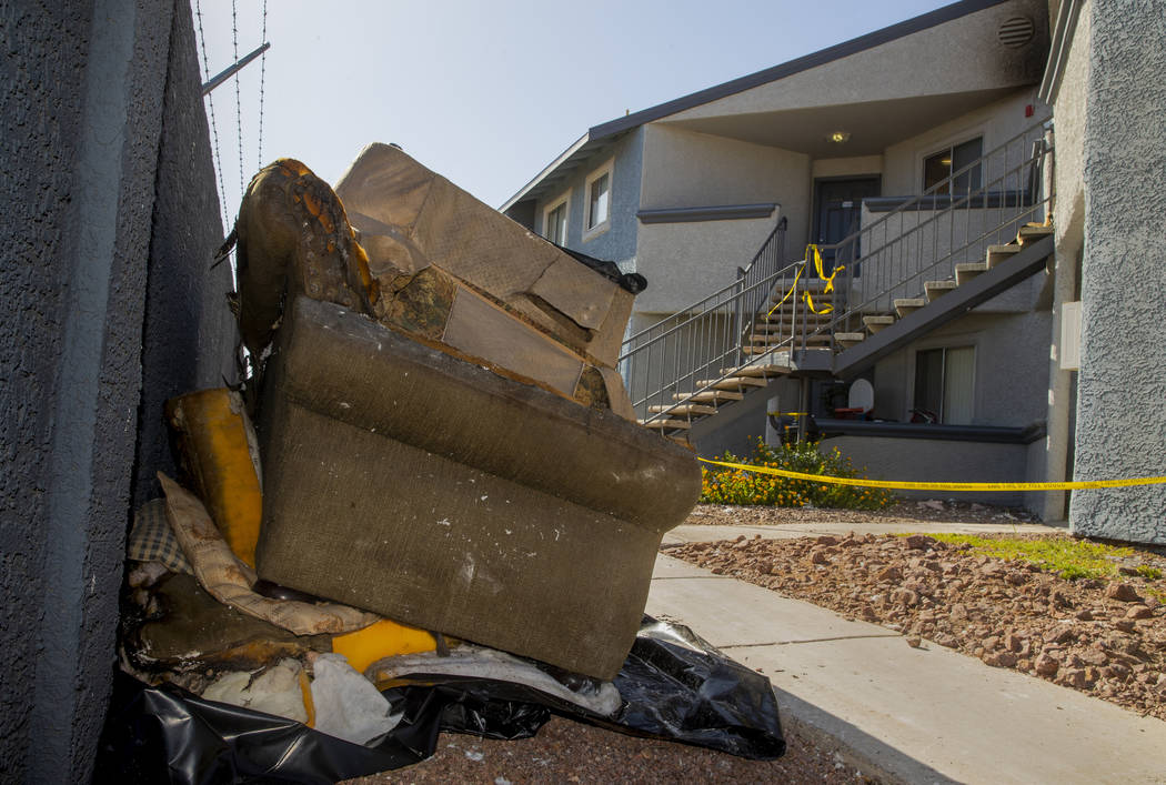 Remains stack up outside from an early morning fire at The Bristol at Sunset apartments in buil ...