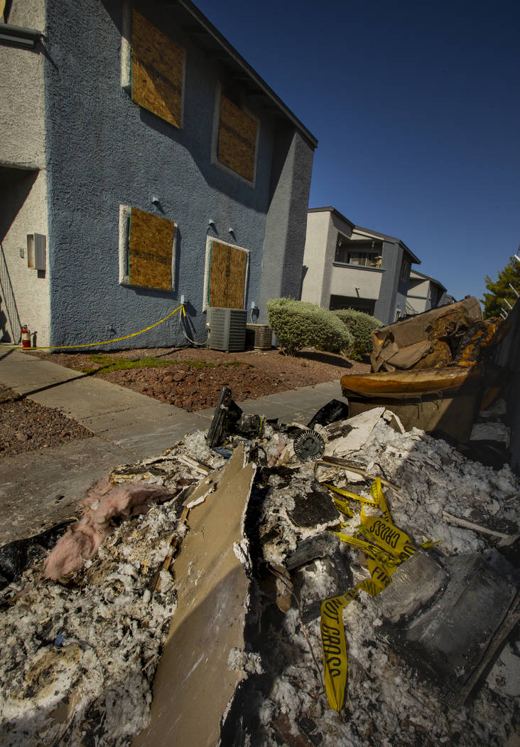 Remains stack up outside from an early morning fire at The Bristol at Sunset apartments in buil ...