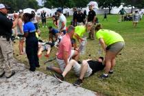Spectators are tended to after a lightning strike on the course left several injured during a w ...