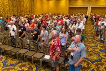 Veterans and spouses stand for "Taps" in honor of those who served in Vietnam attendi ...