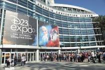 People line up in front of the Anaheim Convention Center during the 2019 D23 Expo on Saturday, ...