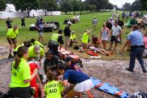 Spectators are tended to after a lightning strike on the East Lake Golf Club course left severa ...