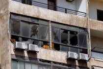 Broken windows are seen on the 11-floor building that houses the media office in a stronghold o ...