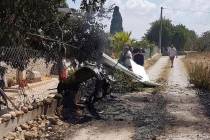 This photo provided by Incendios f.Baleares shows wreckage on a path near Inca in Palma de Mall ...