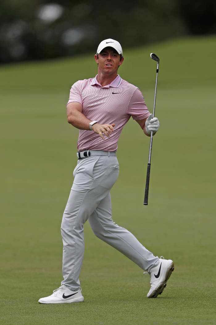 Rory McIlroy reacts as he watches his shot on the second fairway during the final round of the ...