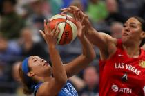 Minnesota Lynx forward Napheesa Collier, center, is fouled by Las Vegas Aces center Liz Cambage ...