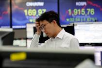 A currency trader watches monitors at the foreign exchange dealing room of the KEB Hana Bank he ...