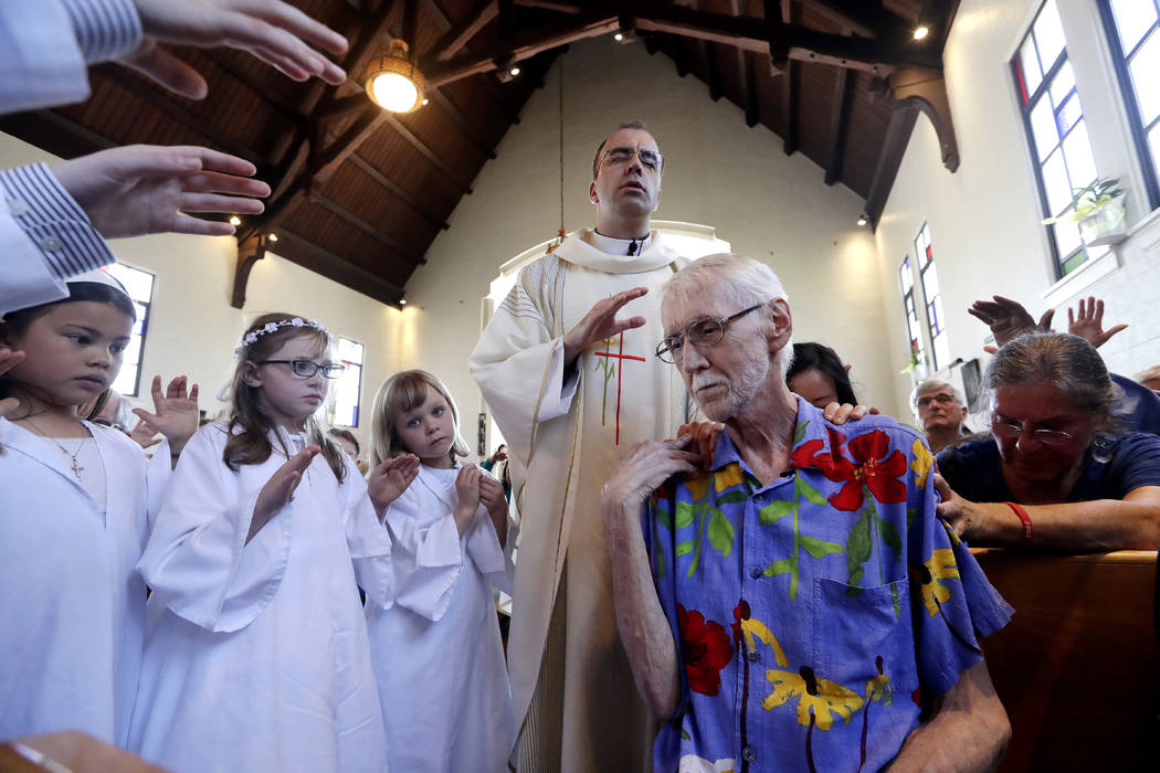 In this May 5, 2019, photo, Robert Fuller, foreground right, receives a blessing and prayer fro ...