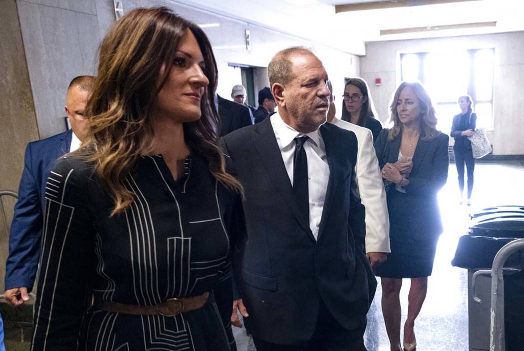 Harvey Weinstein, center, appears in a courthouse for a scheduled arraignment Monday, Aug. 26, ...