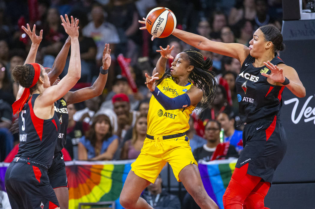 Indiana Fever guard Kelsey Mitchell (0) has a pass deflected by Las Vegas Aces center Liz Camba ...