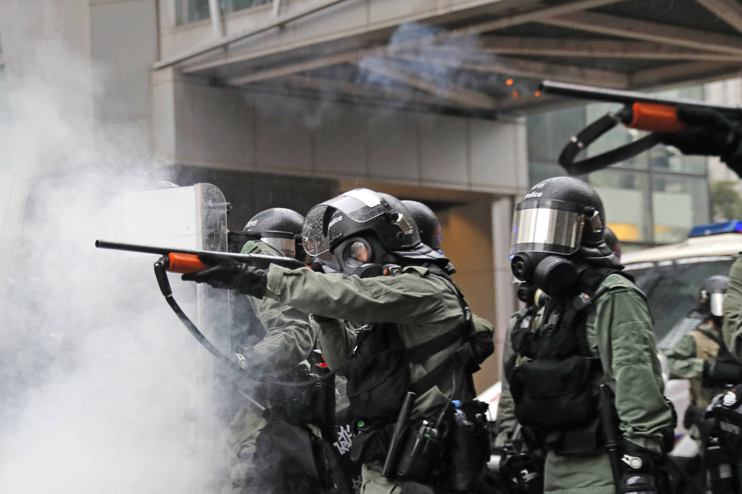 Riot policemen fire weapons during a confrontation with demonstrators during a protest in Hong ...