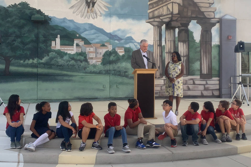 Gov. Steve Sisolak, left, congratulates teacher Gail Hudson, for receiving the Nevada Teacher o ...