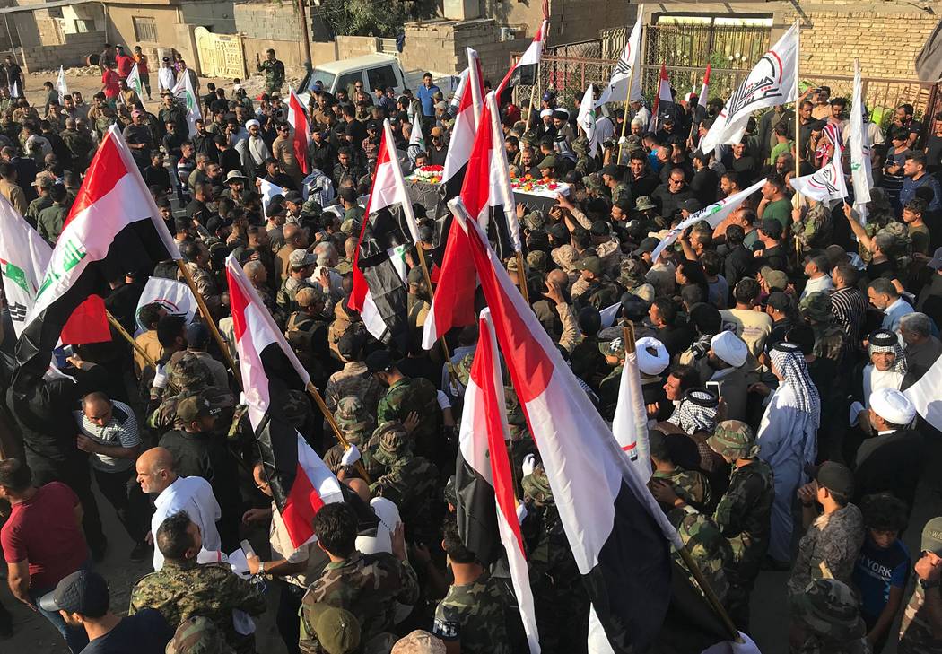Mourners carry the coffin of Abu Ali al-Dabi, a fighter of the Popular Mobilization Forces kill ...