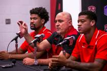UNLV football head coach Tony Sanchez, center, answers a media question beside quarterback Arma ...
