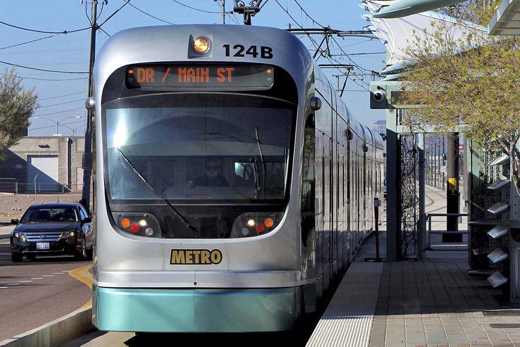 FILE - In this Jan. 16, 2016 file photo, a Metro Light Rail train stops for passengers in Phoen ...