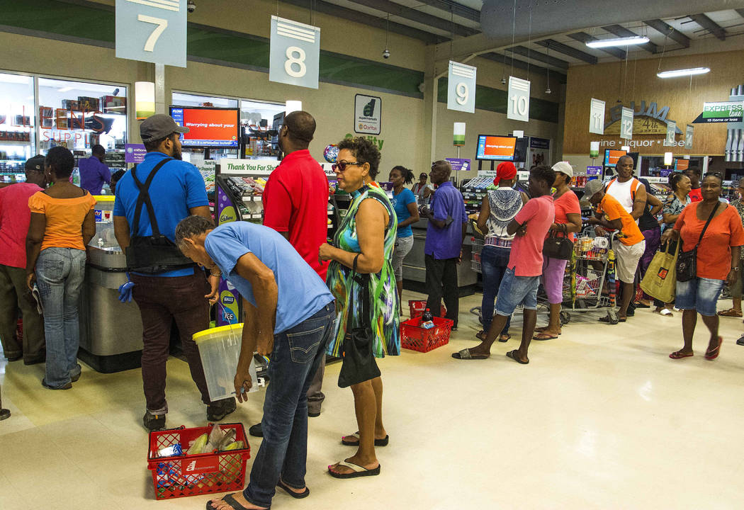 Residents stand in line at a grocery store as they prepare for the arrival of Tropical Storm Do ...